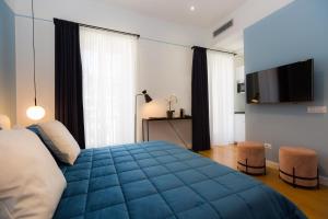 A bed or beds in a room at Suite della Pigna