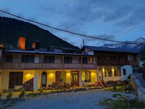 a house with a mountain in the background at Bapsha Guesthouse in Mestia