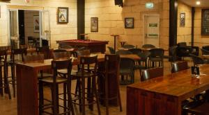 a restaurant with tables and chairs and a pool table at The Kimberley Grande Resort in Kununurra