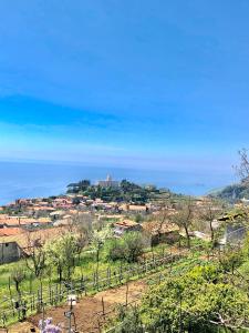a village on a hill with the ocean in the background at La Casa Dei Nonni in Agerola