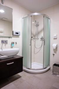 a bathroom with a glass shower and a sink at Apartma Mic *** in Kranjska Gora
