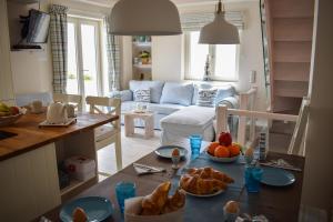 a kitchen and living room with a table with food on it at Blue View House in Corfu