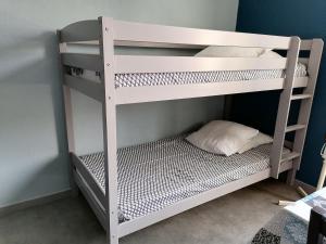 a white bunk bed with a pillow on the bottom bunk at Les Studios proche du Mont Ventoux in Mazan