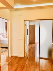 an empty room with a door open to a bedroom at White Tower Mamaia Apartament in Mamaia +13 photos