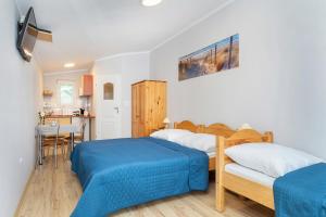 Posteľ alebo postele v izbe v ubytovaní AMBER DZIWNÓW - Pokoje i Apartamenty & SPA
