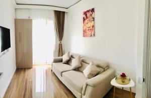 a living room with a couch and a table at White Tower Mamaia Apartament in Mamaia