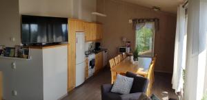 a kitchen with a living room and a kitchen with a table at Stuga i Järvsöbacken in Järvsö