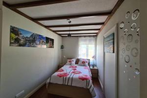 a bedroom with a bed with pink flowers on it at la lauch in Colmar