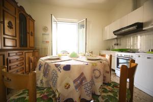 a kitchen with a table with a table cloth on it at RITA'S ROOM ON THE SEA in Giulianova +25 photos