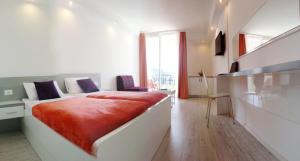 a bedroom with a large bed with a red blanket at White House Lopud in Lopud Island +20 photos