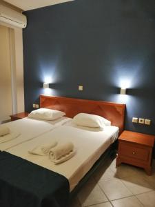 a bedroom with two beds with white towels on them at Eleni Beach Apartment in Stalida