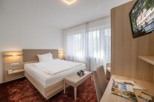Postel nebo postele na pokoji v ubytování Hotel Brenner