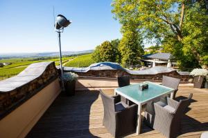 a patio with a table and chairs on a deck at Burg & Gästehaus by Schwarzenstein in Geisenheim +45 photos