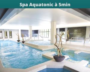 a swimming pool in a hotel with a spa aquariaatlantic akm at J-Mo Home - Chessy - Magnifique vue sur le château in Chessy