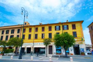 a yellow building on the side of a street at Le Boutique Luxury Rooms diffused in Historic Center in Fiumicino