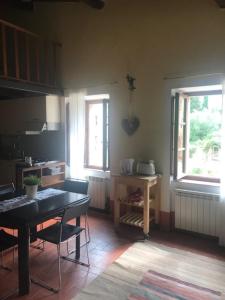 a kitchen with a table and chairs and a window at La Locanda del Loggiato in Bagno Vignoni