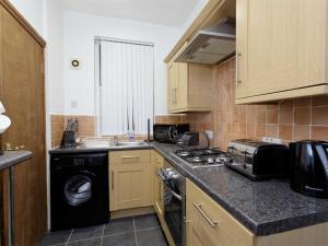 a kitchen with a washer and a sink and a dishwasher at Park house in Leeds