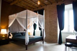 a bedroom with a bed with a canopy at Le Boutique Luxury Rooms in Fiumicino