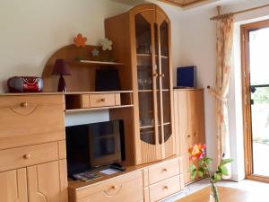 a large wooden entertainment center with a tv in a living room at Ferienwohnung Eckert in Weilheim