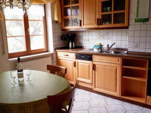 a kitchen with a table with wine glasses on it at Ferienwohnung Eckert in Weilheim