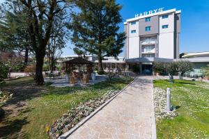 a building with a gazebo in a park at Hotel Harrys' Garden in Abano Terme