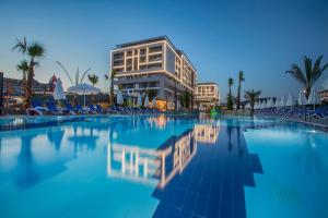 a swimming pool in front of a building at Numa Bay Exclusive Hotel - Ultra All Inclusive in Avsallar +181 photos