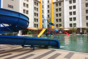 a playground with a slide in a pool of water at Cozy and Sweet Studio at Paramount Skyline Apartment By Travelio in Tangerang +7 photos