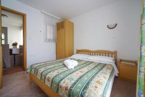 Postel nebo postele na pokoji v ubytování Apartments and Rooms Degra