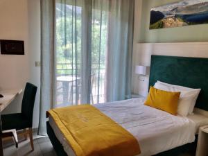 Postel nebo postele na pokoji v ubytování Hotel Limone