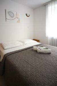 Postel nebo postele na pokoji v ubytování Apartments and Rooms Degra
