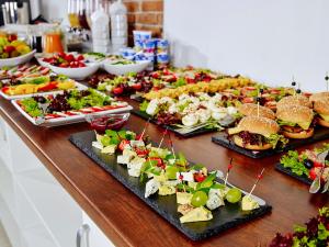 a buffet with many different types of food on a table at Hotel Mużakowski in Łęknica