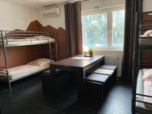 a room with a desk and bunk beds at PREMIUM Hostel in Berlin