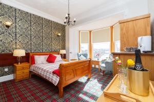 a bedroom with a bed with red pillows at Castle Walk Bed & Breakfast in Stirling