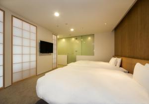Tempat tidur dalam kamar di Daiwa Roynet Hotel Numazu