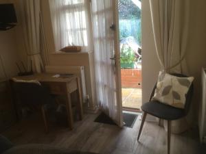 a room with a desk and a chair next to a door at Otters Green in Botley