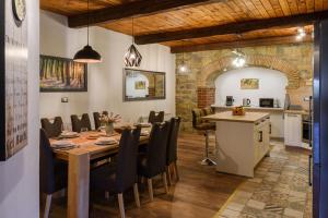 a dining room with a table and a kitchen at The Hug of Nature in Dekani