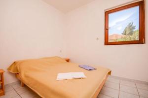 Postel nebo postele na pokoji v ubytování Apartments Ivo