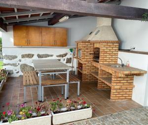 a patio with a table and a brick oven at Casa Leite in Amarante