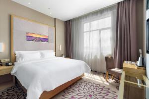 a hotel room with a large bed and a window at Lavande Hotel Tianjin Joy City Gulou Subway Station in Tianjin
