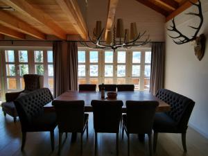 a dining room with a wooden table and chairs at Chalet M in Grindelwald