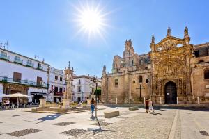 an old building with people standing in front of it at Plaza de Toros 3-Bedroom Apartment with Balcony in El Puerto de Santa María