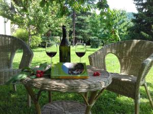 a table with a bottle of wine and two glasses at Villa Della Stua in Cormòns