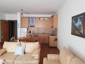 a living room with a couch and a kitchen at Big apartment in Orikum