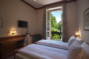 Ένα ή περισσότερα κρεβάτια σε δωμάτιο στο Hotel Le Prese