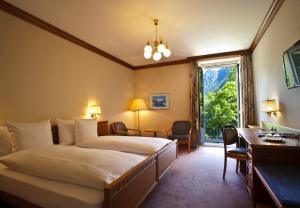 Ένα ή περισσότερα κρεβάτια σε δωμάτιο στο Hotel Le Prese