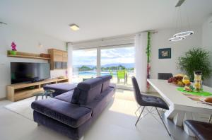 a living room with a couch and a table at Villa Helines***** in Linardići