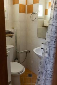 a bathroom with a toilet and a sink at Xsoma Flats "Studio" in Thessaloniki
