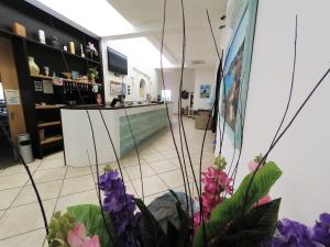 a room with a counter with purple flowers in it at Hotel Alba Chiara Sant'Andrea Salento in SantʼAndrea