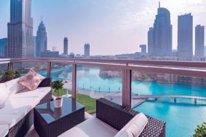 a balcony with a couch and a view of the city at Elite Royal Apartment - Full Bujr Khalifa & Fountain View - Senator - 2 bedrooms & 1 open bedroom without partition in Dubai