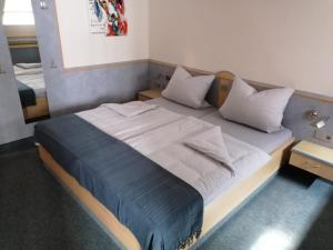 a large bed in a room with two tables at Gasthof-Hotel Biedendieck in Warendorf